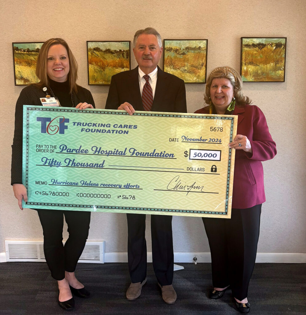 three people holding a large check representing a donation to Pardee Hospital Foundation