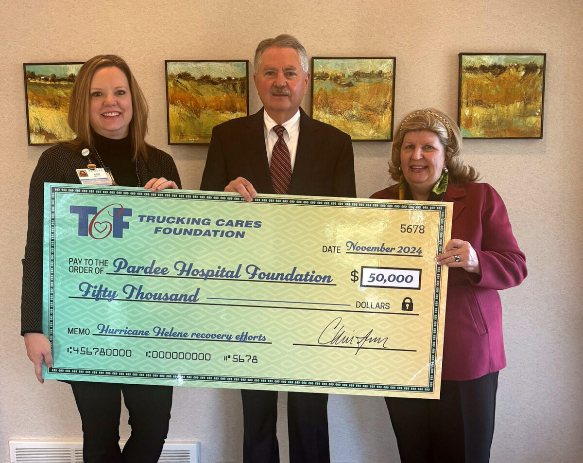 three people holding a large check representing a donation to Pardee Hospital Foundation
